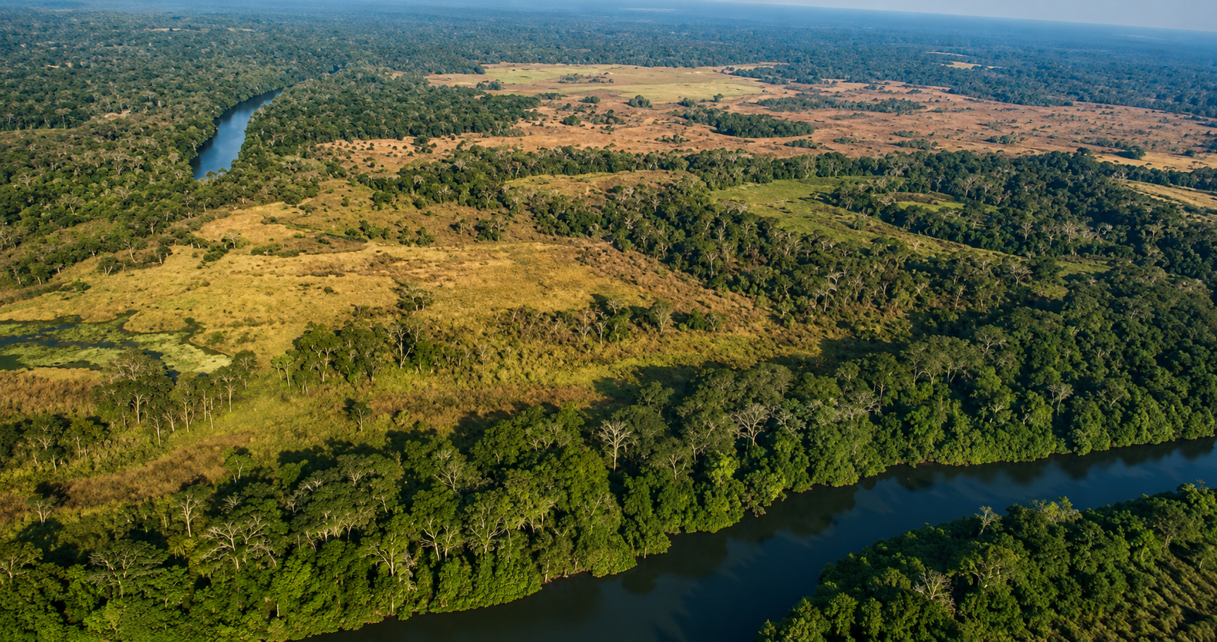 Aerial panorama of the conservancy — rivers winding through miombo woodland and dambo grassland