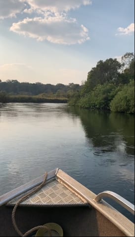Boat on the West Lunga River at dusk
